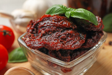 Delicious sun dried tomatoes on wooden table, closeup