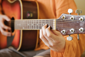 Close-up of the guitarist fingers while playing the guitar. Learning to play the guitar.