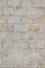 Textured backdrop of weathered beige brick stones creates a rustic cozy ambiance in earthy tones
