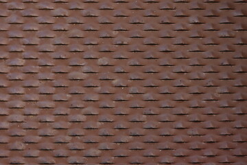 Intricate texture  of metal rust brown panel with openwork holes for a grunge style backdrop