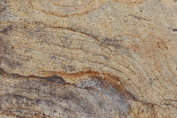 Natural granite stone texture showcasing intricate swirls and rich earthy tones