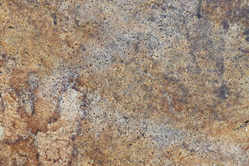 Captivating textures in earthy tones unveil nature's artistry on granite stone surface