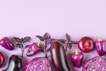 Composition of fresh vegetables eggplants, cabbage, pepper, onion and basil leaves of on pastel lilac lavender background. Creative food concept. Flat lay, top view.