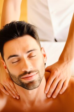 Eyes closed receiving relaxing shoulder and neck massage