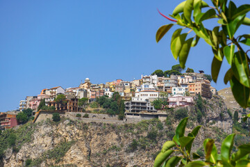 Beautiful view on the hilltop city of Castelmola, a typical sicilian village perched on a mountain, viewed from Taormina in Sicily, Italy  