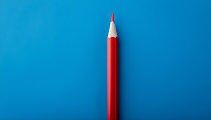 the striking simplicity of a red pencil on blue