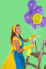 Woman in colorful outfit cleans while holding balloons on a ladder against a bright green background