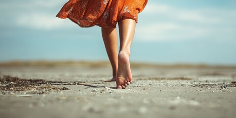 woman with summer pedicure walking barefoot on sand