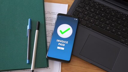 Invoice paid notification on mobile phone. Concept of online payment and ecommerce.