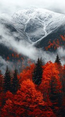 Majestic autumnal mountain range with vibrant fall foliage and snow-capped peaks shrouded in mist