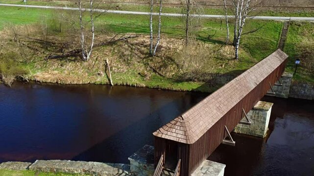 The picturesque covered wooden bridge Rechle near Lenora in the &Scaron;umava mountains &ndash; a unique national cultural monument - historic bridge with a wooden deck and stone pillars