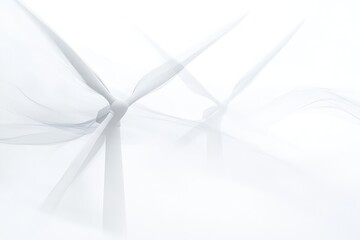 Abstract image of two wind turbines, their blades blurred by motion, suggesting clean energy and sustainable power.