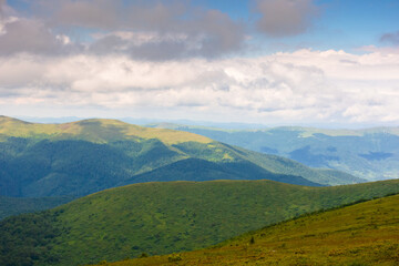 summer landscape with mountain range in cold weather. carpathian watershed ridge and wonderful alps in the distance. alpine scenery under cloudy sky in dappled light