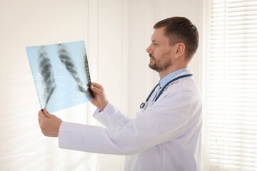 Doctor examining lung MRI scan in clinic