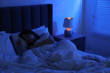 Beautiful woman sleeping in bed at home