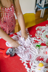 Girl playing with shaving cream exploring sensory activities at preschool