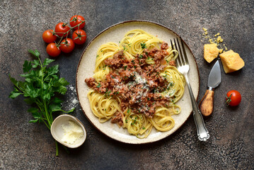 Traditional italian spaghetti bolognese with tomatoes and minced meat. Top view with copy space.