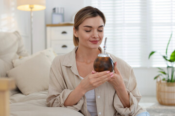 Woman with traditional yerba mate tea at home