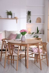 Stylish dining table with chairs in room. Interior design