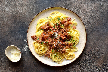 Traditional italian spaghetti bolognese with tomatoes and minced meat. Top view with copy space.