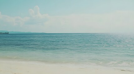 Fototapeta premium Serene Tropical Beach Seascape, Calm Ocean Waves on Sandy Shore