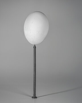 Egg Balanced on a Nail Point