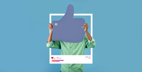 A person holds up a large thumbs up sign framed within a social media backdrop, promoting positivity. The blue background enhances the feeling of approval and connection for online influencers.