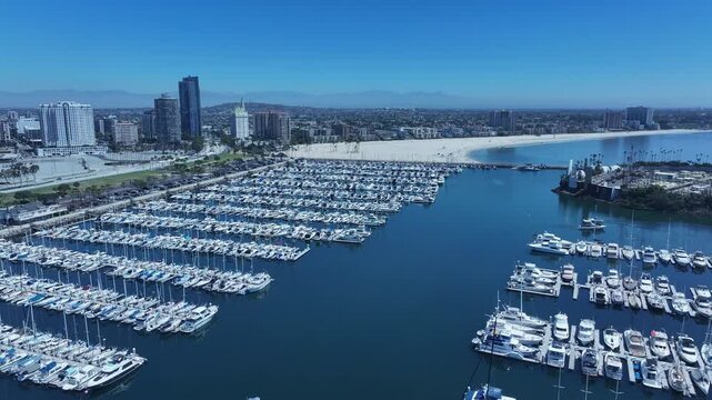 Aerial Long Beach city California marina overhead circle 1. Coastal city near Los Angeles. Cargo and container ship terminal. Cruise ship destination. Seaside resort boat marina and park.