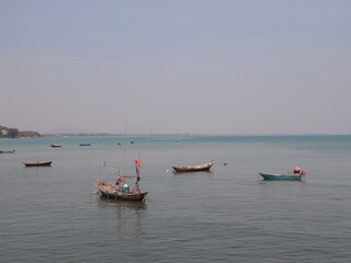 A beautiful and tranquil seascape featuring fishing boats gently floating on calm waters