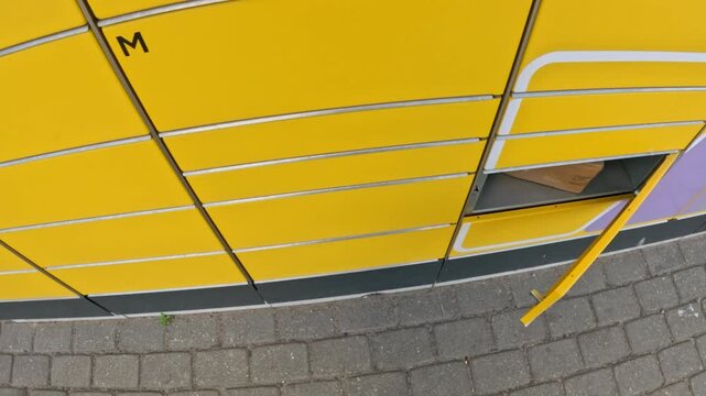 Opening yellow parcel machine door, POV