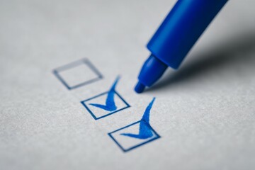 Blue pen checking boxes on paper - concept of task completion and organization