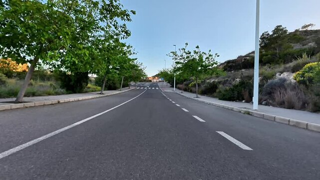 A tranquil road, surrounded by lush greenery, perfect for leisurely walks and exciting cycling adventures