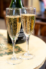 Pouring and tasting of dry sparkling wine brut, grand reserve, champagne in Ay-Champagne wine making village in Vallee de la Marne, , Champagne region, France