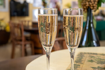 Pouring and tasting of dry sparkling wine brut, grand reserve, champagne in Ay-Champagne wine making village in Vallee de la Marne, , Champagne region, France