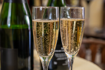 Pouring and tasting of dry sparkling wine brut, grand reserve, champagne in Ay-Champagne wine making village in Vallee de la Marne, , Champagne region, France