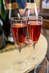 Pouring and tasting of rose or pink cuvee sparkling wine brut, grang reserve, champagne in Ay-Champagne wine making village in Vallee de la Marne, , Champagne region, France