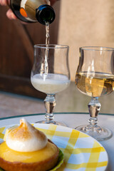 One French lemon tart or tartalette with white eggs meringue and glasses with champange sparkling wine