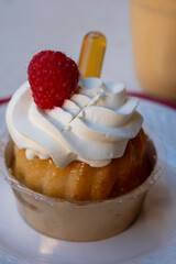 French cuisine, fresh baked baba au rum cake with chantilly cream, sweet dessert with rum close up