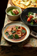 Enjoy a delightful array of culinary creations at a charming restaurant, showcasing a beautifully plated meal with fresh ingredients and rich flavors in a warm atmosphere