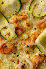 A vibrant selection of shrimp, zucchini, and onions laid out beautifully on a plate, highlighting a culinary masterpiece at a bustling restaurant