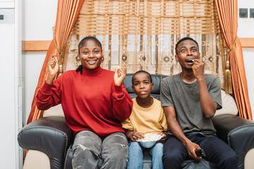 Family Enjoying Home Entertainment While Sharing Popcorn and Creating Memorable Moments