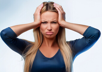 Obraz premium Young woman with a painful expression, holding her head, apparently having a headache, stress, migraine