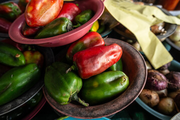 Vegetables, greens and legumes for sale at a street market counter.