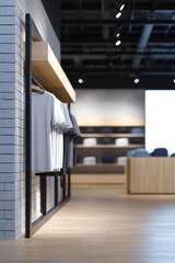 Clothing items are neatly displayed on racks in a modern, spacious store interior. Retail, fashion, organization, contemporary design, shopping