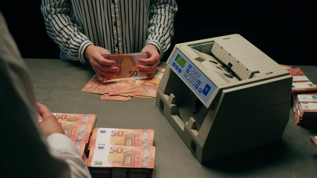 Banknotes and bag counter, Specialised police officer Counting dollar euro banknotes in crime lab with machine, cashed out criminal money, bitcoin changing, buying home flat in bank. 