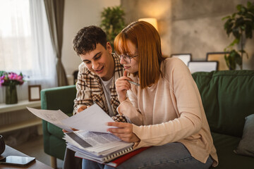 Young couple boyfriend and girlfriend or brother sister study at home