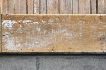 Rough sanded wood board plank or siding or wall with cracks and distressed finish