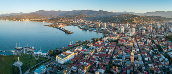 Aerial view of Batumi’s port, waterfront, and historic district with red-roofed buildings.