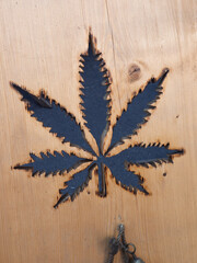 Symbolic Black Marijuana Leaf Engraved on Wood