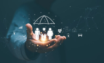 Family life insurance concept, Businessman holding family icon with protection and related icons such as car, home, investments, hospital, savings, travel, Planning for the future life of the family.